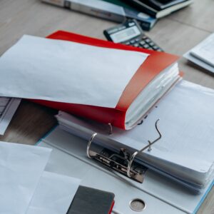 Tidy office desk with binders, papers, and stationery, ideal for business or education themes.